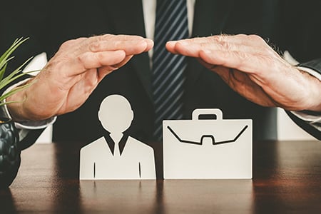 A Business Professional Overseeing Cutouts of an Employee and a Briefcase