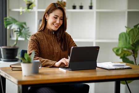 Woman Typing on a Tablet