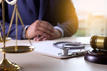 A Manager With Scales and a Gavel on Their Desk