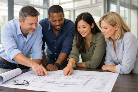 Four Engineers Reviewing Blueprint in Naturally Lit Office-1