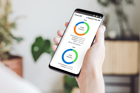 A person using the PRO Software Mobile App to request time off