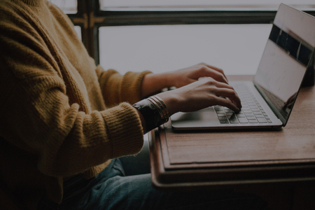 Individual Typing on a Laptop