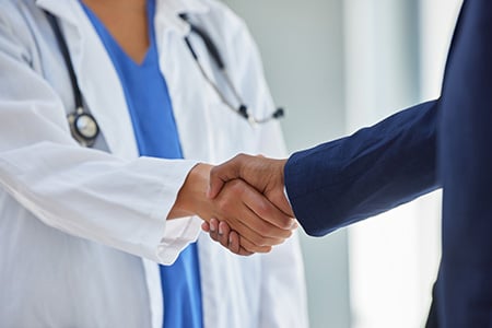 Doctor and Manager Shaking Hands